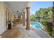 Inviting pool area with patio, built-in grill, and lush landscaping at 7459 Gathering Dr, Reunion, FL 34747