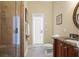 Bathroom with shower, toilet, and granite countertop at 7459 Gathering Dr, Reunion, FL 34747