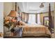Spacious main bedroom with a four-poster bed, and ample natural light at 7459 Gathering Dr, Reunion, FL 34747