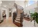 Stunning curved staircase in a bright, spacious entryway at 7459 Gathering Dr, Reunion, FL 34747