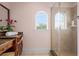 Bathroom with vanity, large shower, and arched window at 7459 Gathering Dr, Reunion, FL 34747