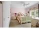 Charming bedroom with floral bedding and french doors to balcony at 7459 Gathering Dr, Reunion, FL 34747