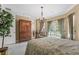 Bright bedroom with a leafy green patterned comforter and a view to a balcony at 7459 Gathering Dr, Reunion, FL 34747