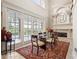 Bright dining room with fireplace, large windows, and pool view at 7459 Gathering Dr, Reunion, FL 34747