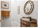 Small powder room with decorative sink and mirror at 7459 Gathering Dr, Reunion, FL 34747