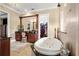 Spa-like Primary bathroom with soaking tub, separate shower, and vanity at 7459 Gathering Dr, Reunion, FL 34747
