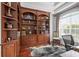 Home office with built-in bookcases and hardwood floors at 7459 Gathering Dr, Reunion, FL 34747
