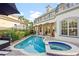 Inviting pool and spa with patio furniture and fire pit at 7459 Gathering Dr, Reunion, FL 34747