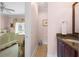 Small half bathroom with vanity and toilet at 7459 Gathering Dr, Reunion, FL 34747