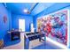 Fun game room with foosball, air hockey, and Marvel artwork at 3028 Protagonist St, Kissimmee, FL 34746