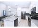 Modern kitchen featuring stainless steel appliances and an island at 3028 Protagonist St, Kissimmee, FL 34746