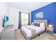 Comfortable bedroom with a TV and modern decor at 3028 Protagonist St, Kissimmee, FL 34746