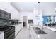 Modern kitchen with white cabinets and stainless steel appliances at 3028 Protagonist St, Kissimmee, FL 34746