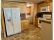 Kitchen with refrigerator, range, and access to laundry area at 5013 Foxwood Blvd, Lakeland, FL 33810