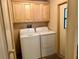 Convenient laundry room with washer, dryer, and overhead cabinets at 5013 Foxwood Blvd, Lakeland, FL 33810