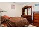 Cozy bedroom with a double bed and wooden dresser at 2419 Willow Tree Ln, Kissimmee, FL 34758