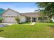 One-story house with attached garage and a well-maintained lawn at 2419 Willow Tree Ln, Kissimmee, FL 34758