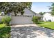 Attached garage with a double door and a concrete driveway at 2419 Willow Tree Ln, Kissimmee, FL 34758