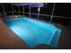 Night view of a relaxing screened-in pool and spa at 730 Brunello Dr, Davenport, FL 33897