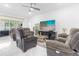 Bright living room featuring a large TV and comfortable seating at 870 E 19Th St, Saint Cloud, FL 34769