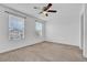 Bright bedroom with two windows, ceiling fan, and neutral carpet at 3920 Saltmarsh Loop, Sanford, FL 32773