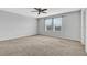 Spacious bedroom with neutral walls, ceiling fan, and plush carpeting at 3920 Saltmarsh Loop, Sanford, FL 32773