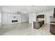 Open concept living room with kitchen, fireplace, and tile flooring at 3920 Saltmarsh Loop, Sanford, FL 32773