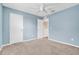 Well-lit bedroom featuring a ceiling fan and ample closet space at 3920 Saltmarsh Loop, Sanford, FL 32773