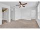 Bedroom with ceiling fan, carpet, and access to bathroom and closet at 3920 Saltmarsh Loop, Sanford, FL 32773