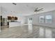Open living room with tile floors, modern ceiling fan, and kitchen island at 3920 Saltmarsh Loop, Sanford, FL 32773