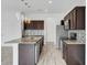 Modern kitchen featuring granite countertops, stainless steel appliances, and dark wood cabinetry at 3920 Saltmarsh Loop, Sanford, FL 32773