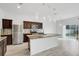 Spacious kitchen with granite island, stainless steel appliances, and tile floors at 3920 Saltmarsh Loop, Sanford, FL 32773