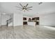Bright and spacious living area with kitchen and staircase views at 3920 Saltmarsh Loop, Sanford, FL 32773