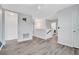 Bright hallway with wood-look flooring and access to other rooms at 3920 Saltmarsh Loop, Sanford, FL 32773