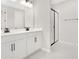 Bathroom with white cabinets, double vanity, and glass shower at 4252 Sawtooth Ct, Tavares, FL 32778