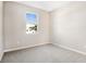 Simple bedroom with neutral walls and grey carpeting at 4252 Sawtooth Ct, Tavares, FL 32778