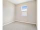 Simple bedroom with neutral walls and grey carpeting at 4252 Sawtooth Ct, Tavares, FL 32778