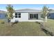 Back of house showing patio and landscaping at 4252 Sawtooth Ct, Tavares, FL 32778