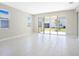 Living area with tile floors and sliding glass doors opening to a patio at 4252 Sawtooth Ct, Tavares, FL 32778