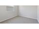 Small bedroom with neutral carpet and walls at 4256 Sawtooth Ct, Tavares, FL 32778