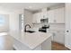 Modern kitchen featuring white cabinets, quartz countertops, and stainless steel appliances at 4256 Sawtooth Ct, Tavares, FL 32778