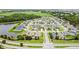 An aerial view of the neighborhood with surrounding trees and bodies of water at 2894 Mosshire Cir, Saint Cloud, FL 34772
