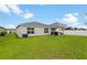 Fenced backyard with covered patio and lush lawn at 2894 Mosshire Cir, Saint Cloud, FL 34772