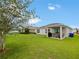 Covered back patio with furniture and green lawn at 2894 Mosshire Cir, Saint Cloud, FL 34772