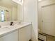 Bathroom boasts dual sink vanity, white cabinets, and separate toilet at 2894 Mosshire Cir, Saint Cloud, FL 34772