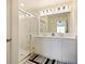 Modern bathroom with dual vanity, shower, and white cabinetry at 2894 Mosshire Cir, Saint Cloud, FL 34772