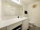 Modern bathroom with sleek white vanity, mirror, and contemporary fixtures at 2894 Mosshire Cir, Saint Cloud, FL 34772