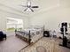 Main bedroom with ceiling fan, carpet, and ensuite bathroom at 2894 Mosshire Cir, Saint Cloud, FL 34772