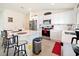 Modern kitchen featuring white cabinets, stainless steel appliances, and an island with bar seating at 2894 Mosshire Cir, Saint Cloud, FL 34772