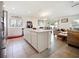 Open-concept kitchen and living area with an island, white cabinets, and stainless steel appliances at 2894 Mosshire Cir, Saint Cloud, FL 34772